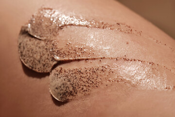 Fototapeta premium Coffee cream scrub on human skin close-up.