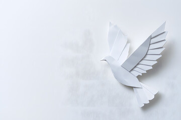 White flying origami bird made of white folded paper, symbolizing peace , isolated on white background