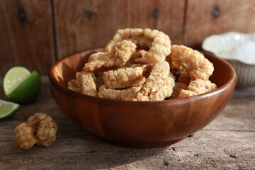 Bowl of crispy pork cracklings or pork rind. Asian food appetizer.