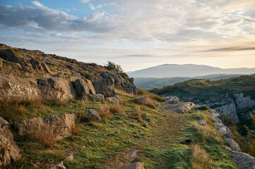 Path in the mountains. Rocky landscape with mountain views in the background.