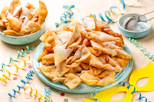 Angel wings or bugnes, bugie, or chvorost; faworki. Traditional carnival sweet crisp pastry deep-fried and sprinkled with powdered sugar.