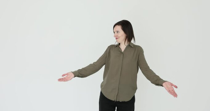 Portrait of woman shrugging shoulders and throwing up hands with helplessness on white background