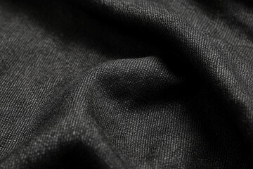 Fototapeta premium Close-up shot of dark black fabric with smooth texture and fine weave