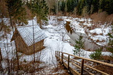 Shed for resting on the bank of river.  View from the hill and stairs. Kartavkalna Nature Trail, Latvia.