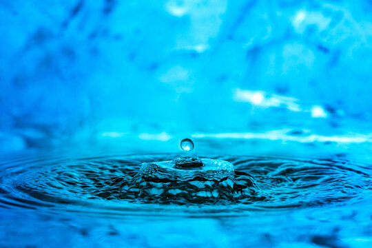 Explosion of water drop on blue background