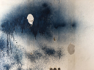 Fragment of an old wall with paint drips, cracks and holes. Structure of an old wall. Architectural...