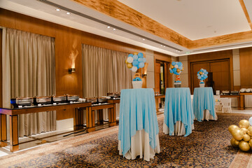 Elegant event space decorated with light blue tablecloths and balloon centerpieces.  Perfect for a special celebration.