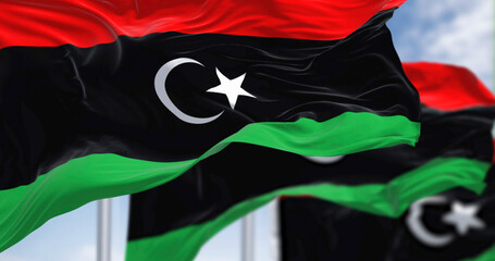 National flags of Libya waving on a clear day.