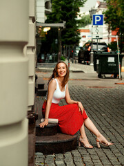 Beautiful girl walks in the summer town