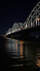 Nighttime portrait of Baton Rouge Bridge against the Mississippi River backdrop in Louisiana