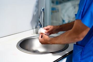 hospital nurse performing hand washing procedure