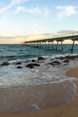 Obraz premium waves crashing under the Anis del Mono bridge in Badalona