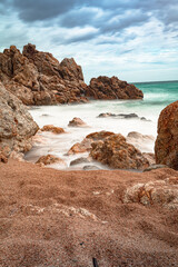 long exposure against the rocks on the beach