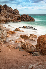 long exposure against the rocks on the beach