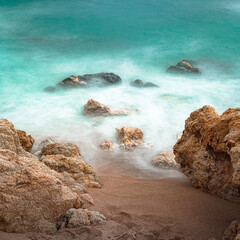 long exposure against the rocks on the beach