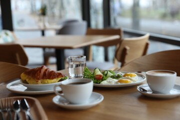 Delicious breakfast served on wooden table in cafe