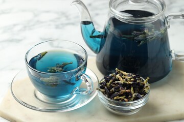 Delicious butterfly pea flower tea on light table, closeup