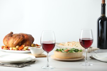 Red wine and delicious dinner served on light table