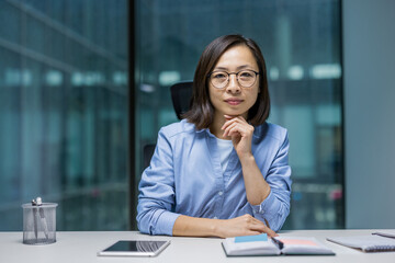 Portrait of confident Asian businesswoman. Office worker looking intently at camera, woman at...