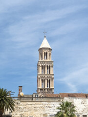Split, Croatia - July 1, 2024: Coastal boardwalk. Saint Domnius Cathedral tower peeks over historic Diocletian's Palace walls.
