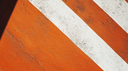 Textured orange and white diagonal stripes on a weathered tennis court surface highlighting vibrant colors and urban sports aesthetics.