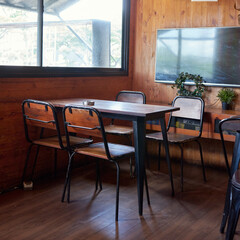 A warm and inviting dining area features a wooden table and chairs, situated in a mountain retreat with a lovely view outside