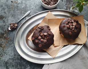 chocolate muffins seen from above on silver plate and gray background