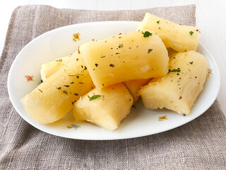 Cooked cassava in white porcelain shape and light background