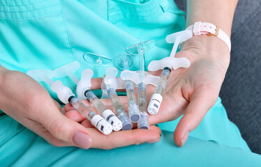 doctor holds medicine bottle vaccine