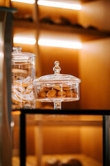Delicious cookies displayed in a jar on a window ledge at a charming coffee shop in the afternoon light