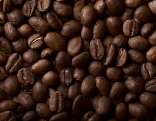 Naklejka premium A pile of dark roasted coffee beans as background.