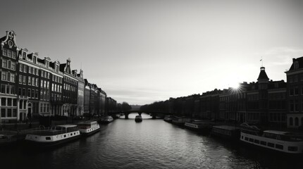 Fototapeta premium Amsterdam Canal Sunset: Monochromatic Cityscape with Boats