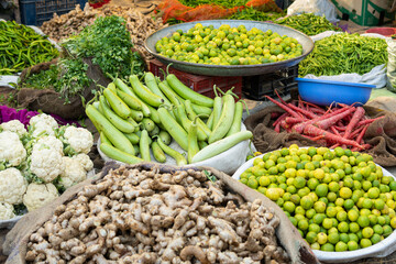 Vegetable market stall with ginger, lime, cabbage, pepper and greenery in Rajasthan, India