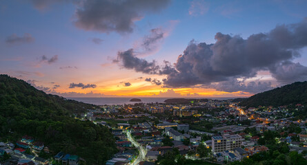 Aerial view colorful sky above The city next to Kata Beach is a popular tourist attraction The lights along the beach begin to turn on as dusk approaches. clouds floats above the sea..