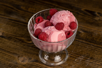 delicious sweet cold raspberry flavored ice cream and ripe raspberries in a glass