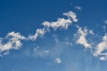 Thin streaks of feathery clouds cross the blue firmament.