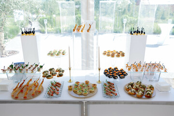 Catering service presenting finger food and appetizers on a table for a luxury event