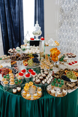 Catering service presenting delicious desserts and pastries on glass stands