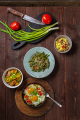 Set table, Jewish food, tzimmes, chelnt, shakshuka and couscous