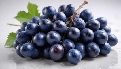 Fototapeta premium Close-up of blue wet grapes bunch on a white surface with subtle texture and reflections, wet grapes, texture, blue grapes