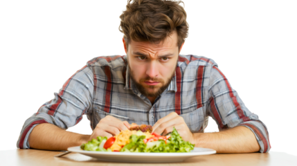 Man in a plaid shirt sitting at a table with a worried expression, looking at his plate of healthy salad, reflecting on his food choices and balancing diet in a modern dining setting