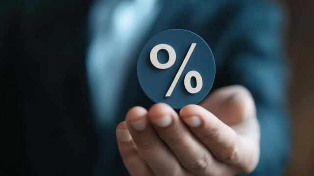 Businessman presenting a floating percentage symbol, embodying interest rates, financial growth, investment opportunities, and loan calculations in the financial market