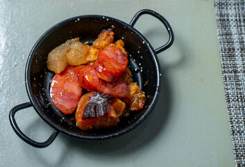 A small pot with traditional Alentejo sausages and fried pork lard, ready to be added to the...