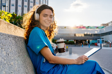Beautiful young nurse or doctor strolling in the city