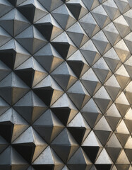 Obraz premium Architectural Facades: Reflective Triangular Metallic Panels Forming an Abstract Geometric Pattern, Showcasing Innovative Architectural Design