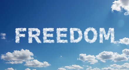 Vast blue sky filled with puffy white clouds. Freedom spelled out in clouds.  Beautiful nature outdoors.
