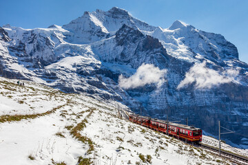 Sunny winter day, the train between Jungfraujoch (Top of Europe) and Kleine Scheidegg on the snowy...