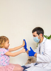 Fototapeta premium A child is being treated by a doctor in a clinic. Selective focus.