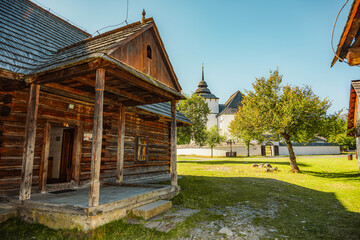 Rare wooden bell tower with folk houses located in open-air museum of Liptov Village, Slovakia - Pribylina