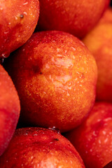 a small harvest of ripe washed nectarines in drops